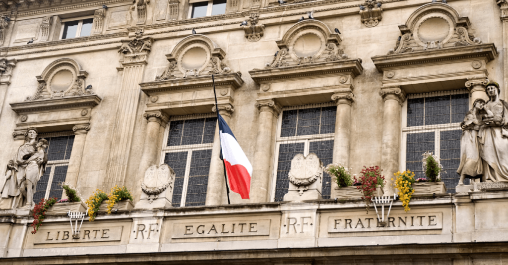 French core values engraved on building with French flag above
